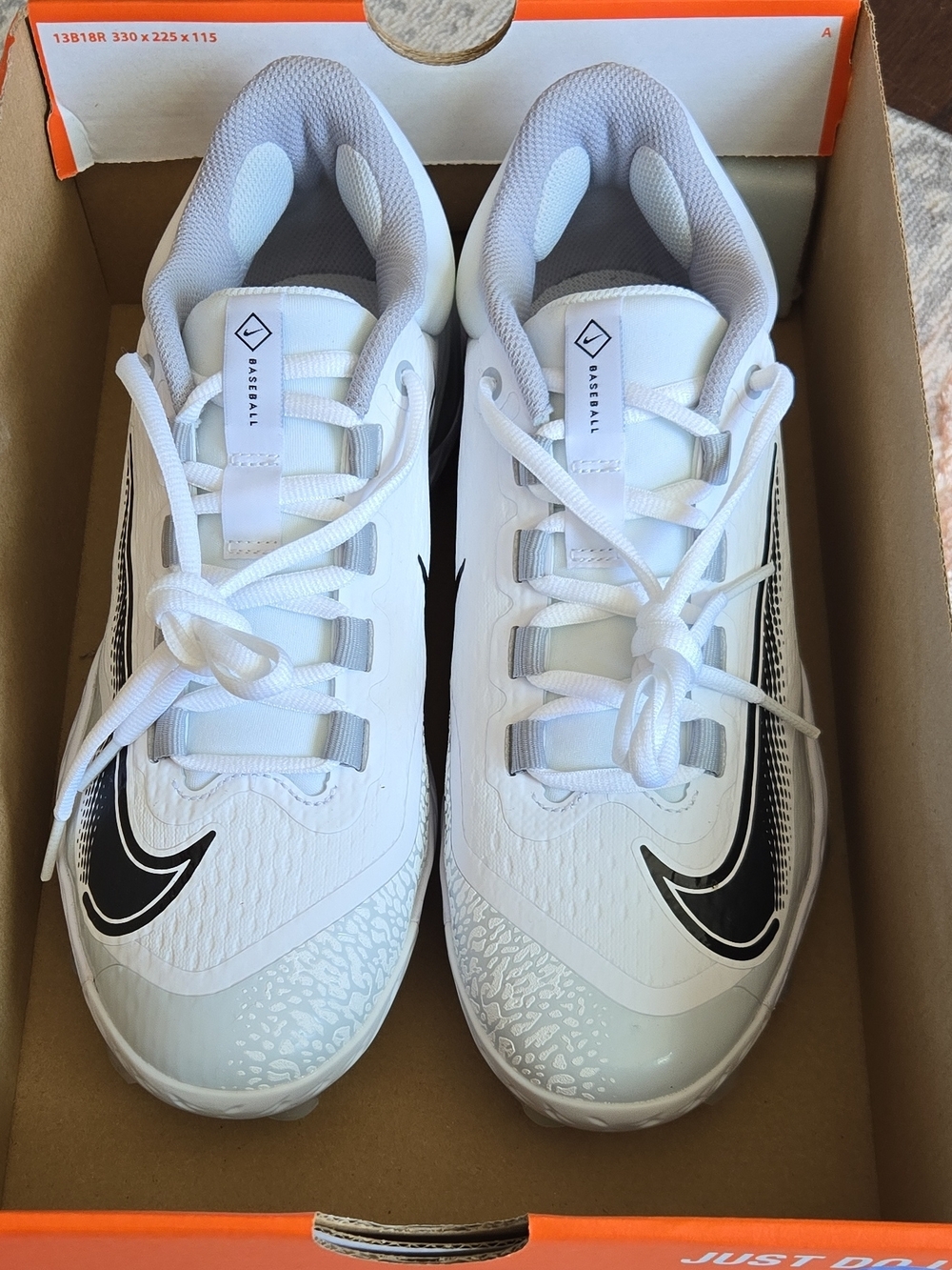 Nike White Cleats with Black Swoosh and Gray Lining